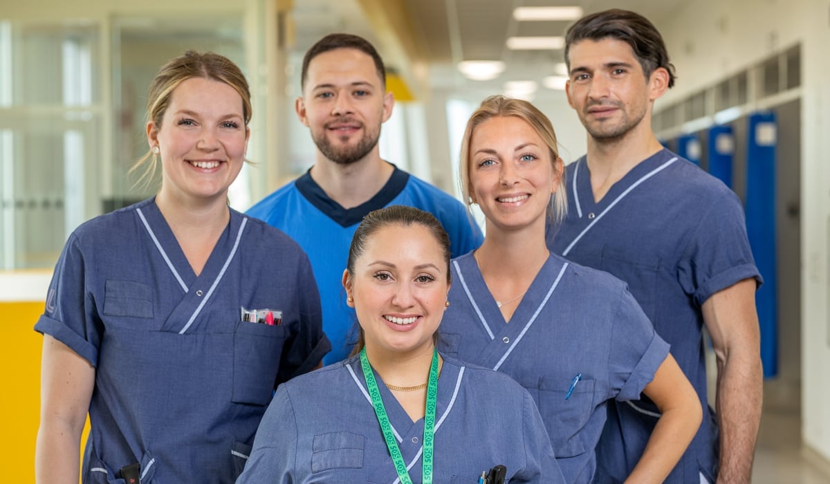 gruppbild fem medarbetare i sjukhusmiljö